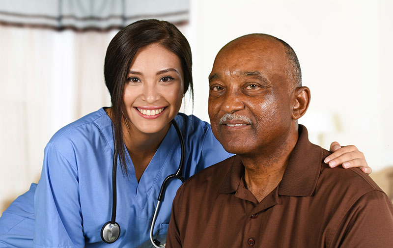 Nurse and older man smiling